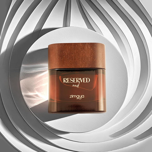 Wooden jar with 'Reserved oud' and 'zimaya' text on a gray and white circular background