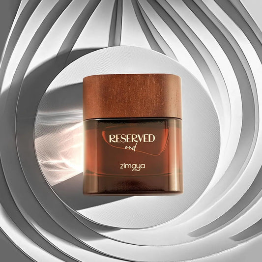 Wooden jar with 'Reserved oud' and 'zimaya' text on a gray and white circular background