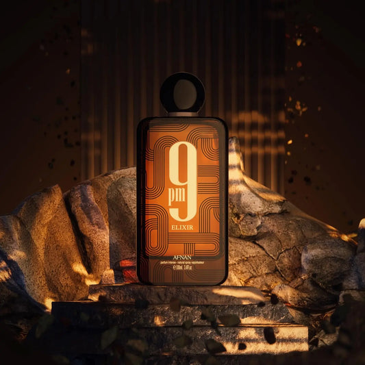 Perfume bottle labeled '9pm Elixir' by Afnan on a dark background