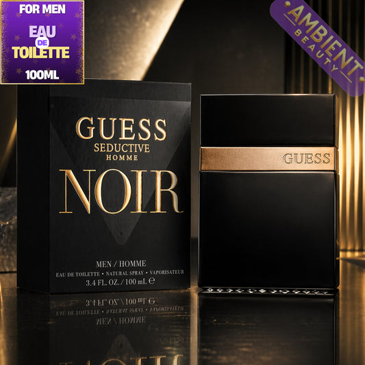 Guess Seductive Homme Noir perfume bottle and packaging on a reflective surface with 'Ambient Beauty' branding.