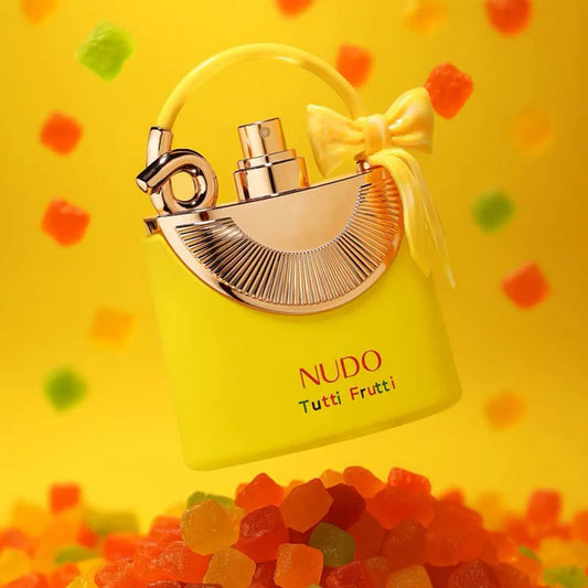 Yellow Nudo Tutti Frutti perfume bottle with a bow on a yellow background with colorful shapes.