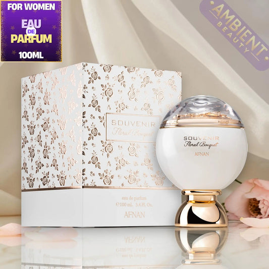 SOUVENIR floral bouquet perfume bottle and packaging on a reflective surface with 'Ambient Beauty' branding.