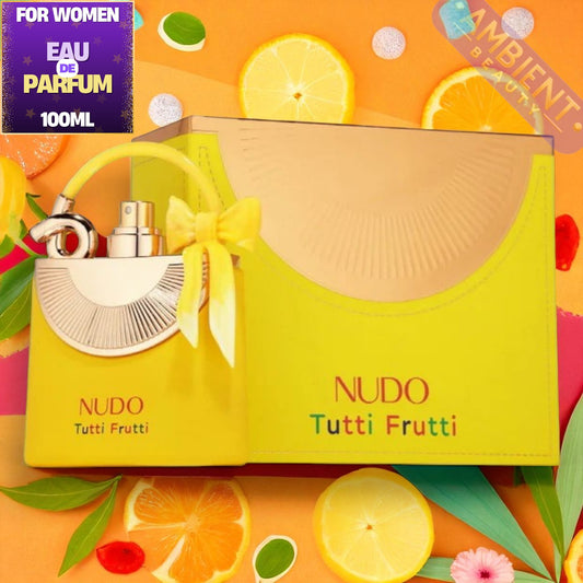 Nudo Tutti Frutti perfume set with yellow box and fruit-themed design on an orange background