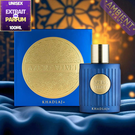 Khadraj Azure Velvet Unisex Extrait de Parfum 100ml bottle and its blue packaging box, both featuring a gold circular emblem, set against a dark background with warm golden bokeh and draped blue fabric.