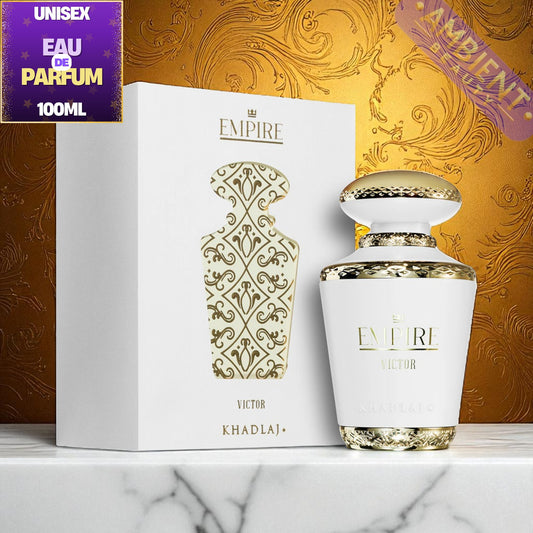 White and gold Khadlaj Empire Victor perfume bottle with packaging on a marble surface and decorative background