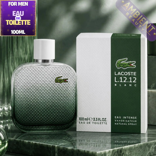 Lacoste L.12.12 Blanc perfume bottle and packaging on a marble surface with greenery in the background.