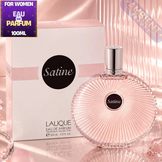 Lalique Satine perfume bottle and packaging on a reflective surface with 'Ambiente' branding.