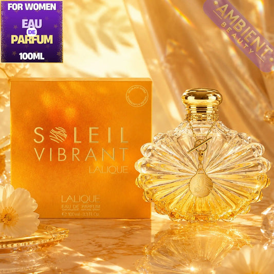 Lalique Soleil Vibrant perfume bottle and packaging on a reflective surface with 'Ambient Beauty' branding.