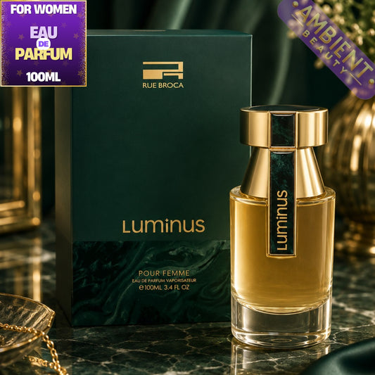 Rue Broca Luminus perfume bottle and packaging on a reflective surface with 'Ambient Beauty' label.