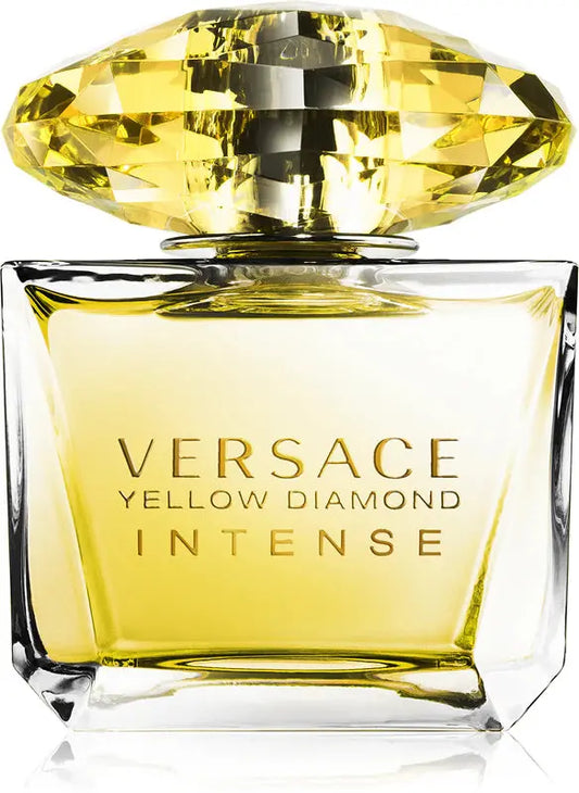 Versace Yellow Diamond Intense perfume bottle with yellow gemstone cap on a white background