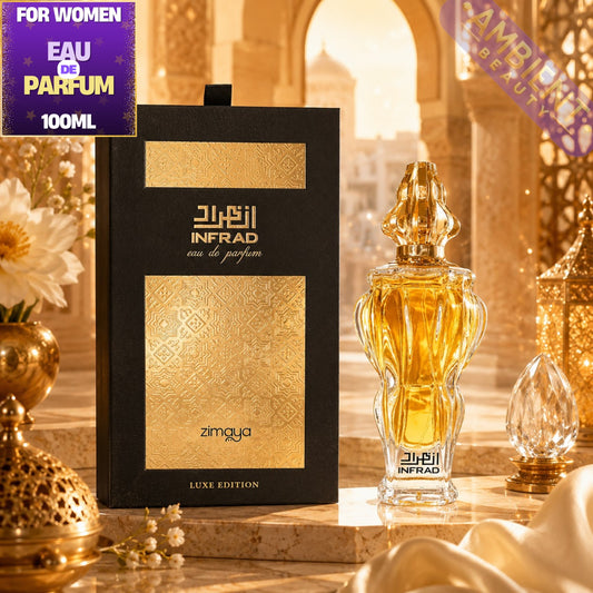 Zimaya Infrad Luxe Edition Eau de Parfum bottle and packaging box displayed in an ornate golden Moroccan-themed setting. The bottle is filled with amber-colored fragrance and features a detailed gold cap, standing next to its black and gold outer box.