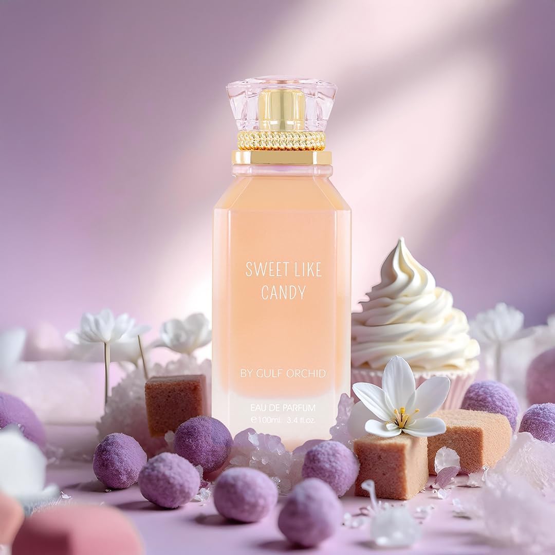 Perfume bottle labeled 'Sweet Like Candy' with candy and dessert-themed decorations on a pink background