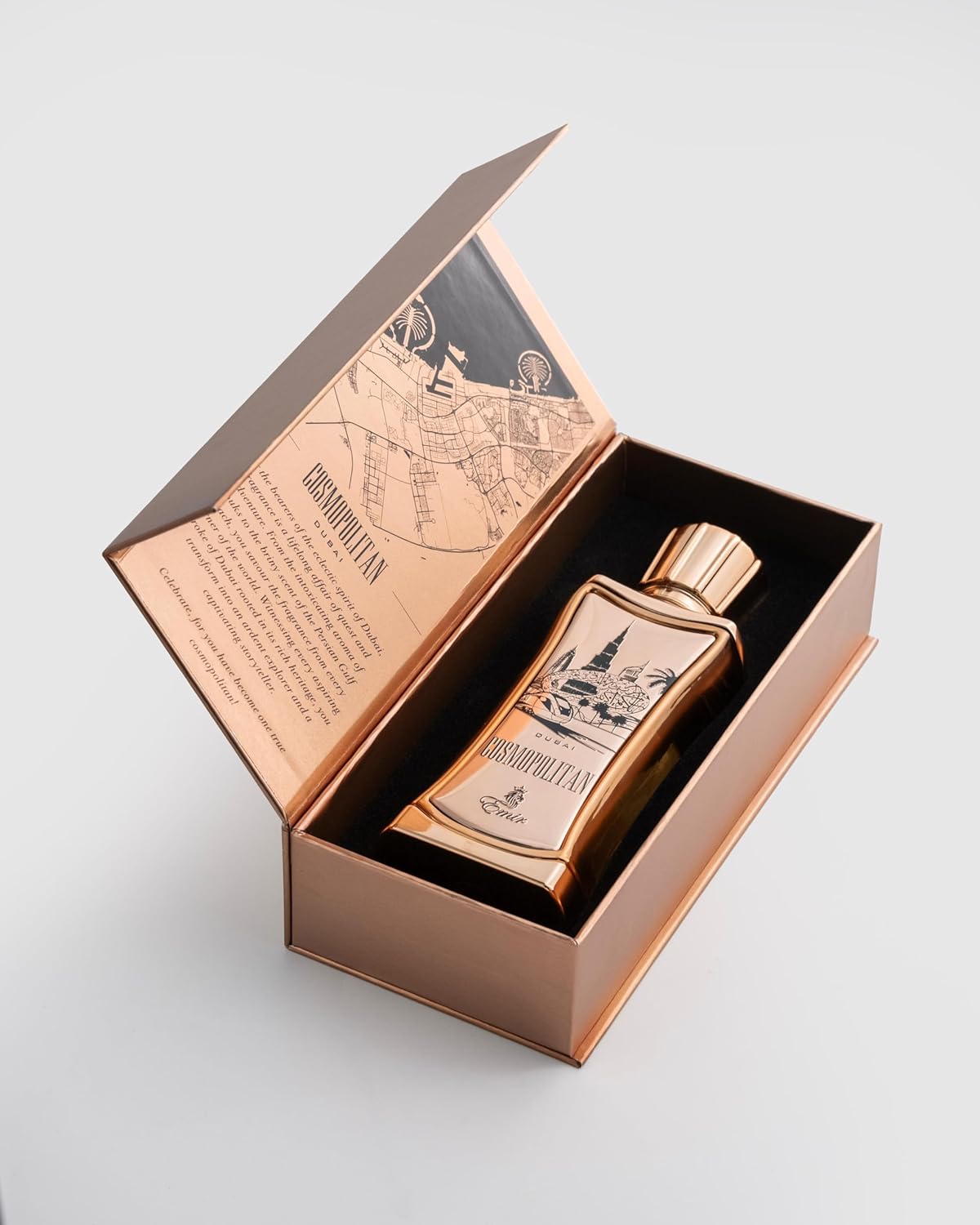 Emir Cosmopolitan Dubai Bronze bottle with decorative label in an open box on a light gray background