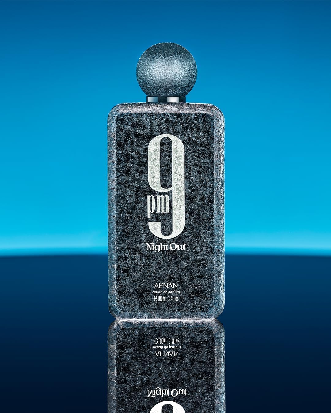 Black textured bottle labeled '9 pm Night Out' on a blue gradient background