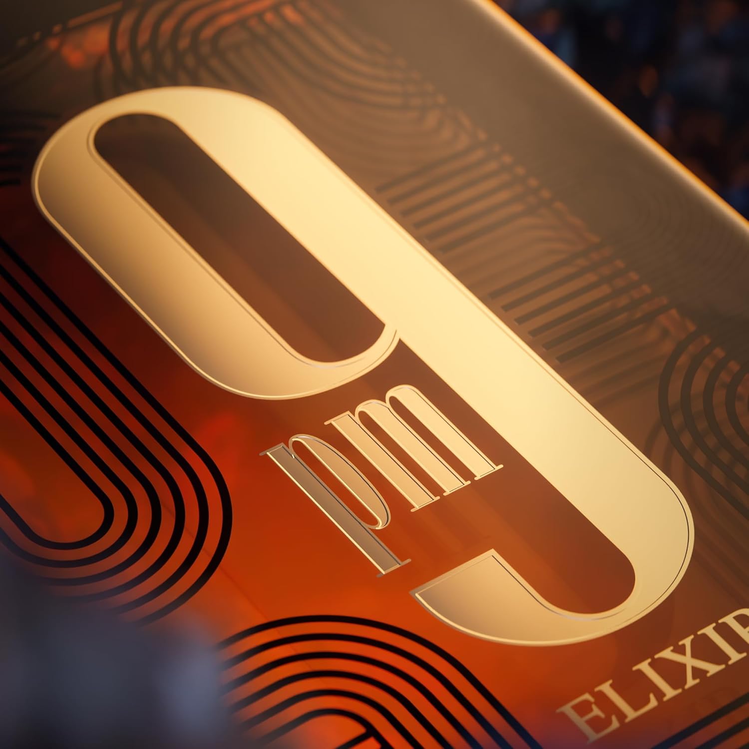 Close-up of a gold and red label with '9pm Elixir' branding on a dark background.