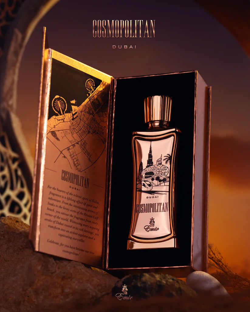 Emir Cosmopolitan Dubai perfume bottle in an open book-shaped box with a warm background.