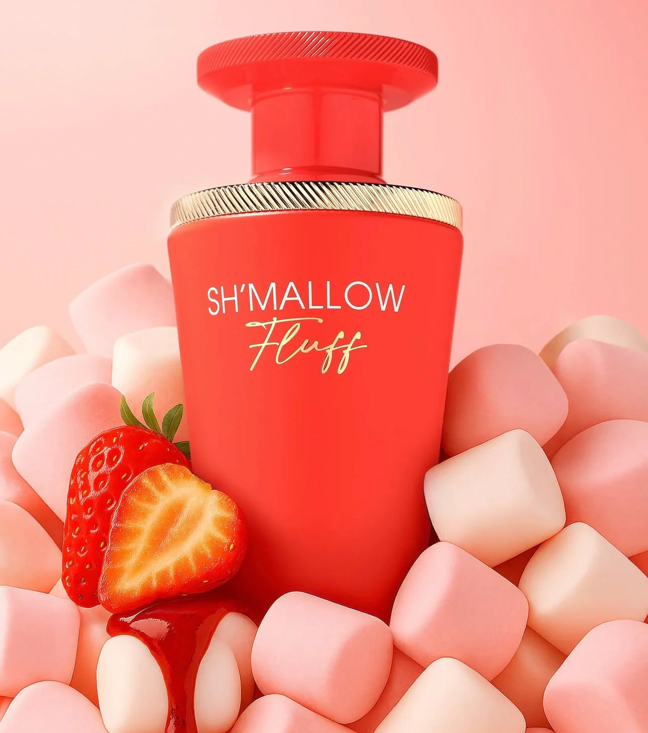 Red bottle labeled 'SH'MALLOW Fluff' surrounded by strawberries and marshmallows on a pink background