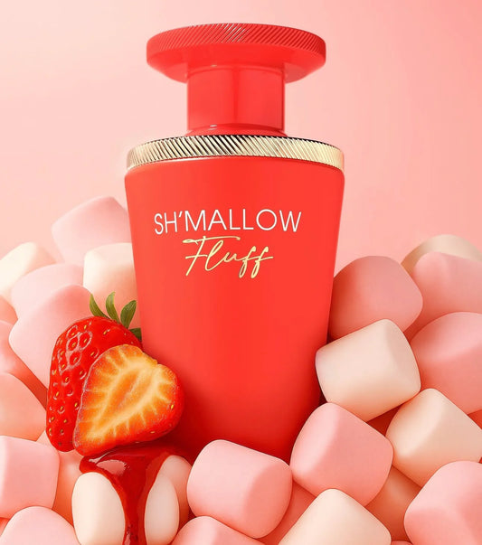 Red bottle labeled 'SH'MALLOW Fluff' surrounded by strawberries and marshmallows on a pink background