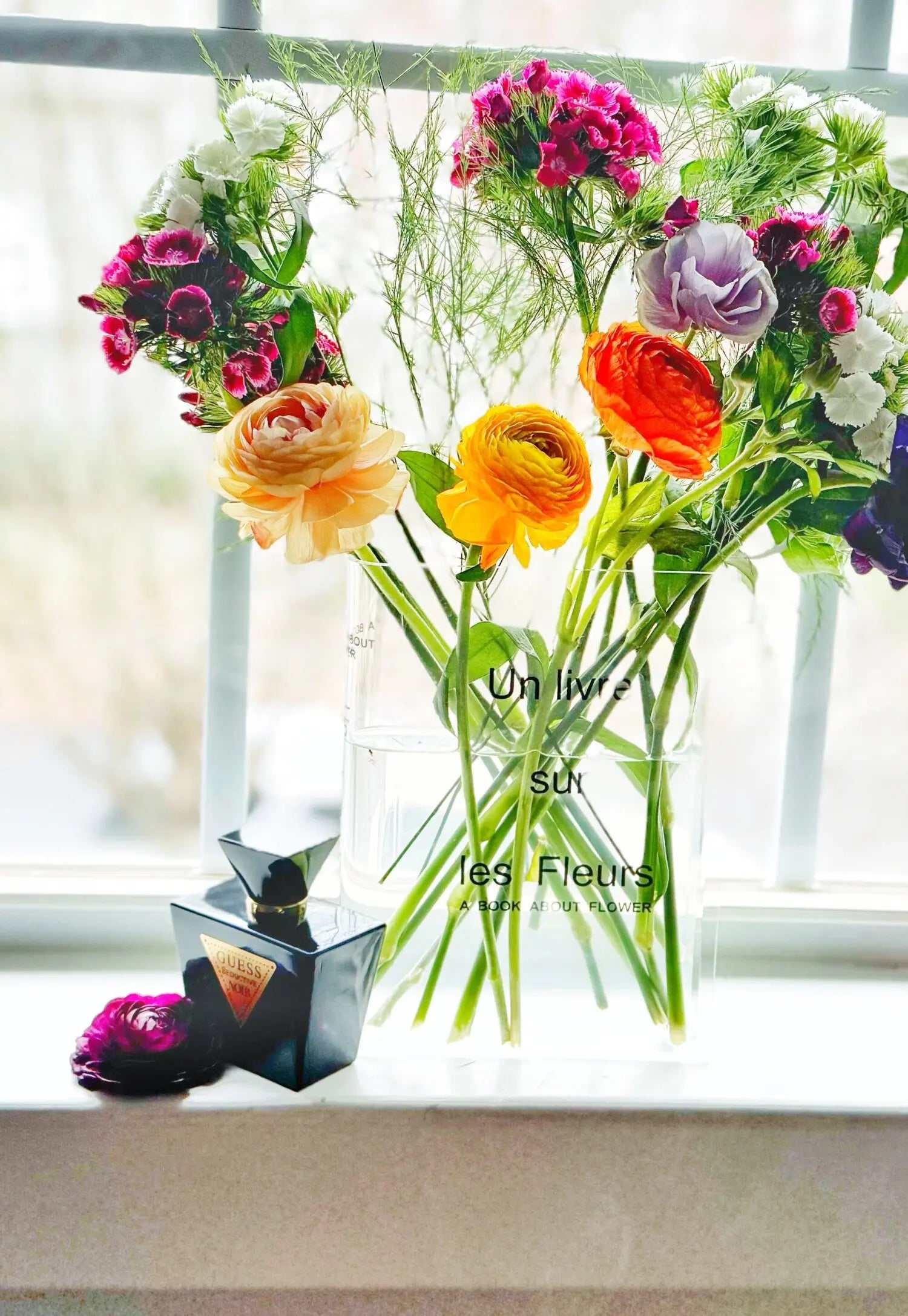 Vase with colorful flowers on a windowsill