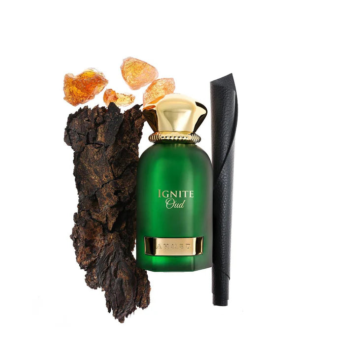 Ahmed Al Maghribi Ignite oud Green perfume bottle labeled 'Ignite Oud' with amber stones and a wooden stick on a white background