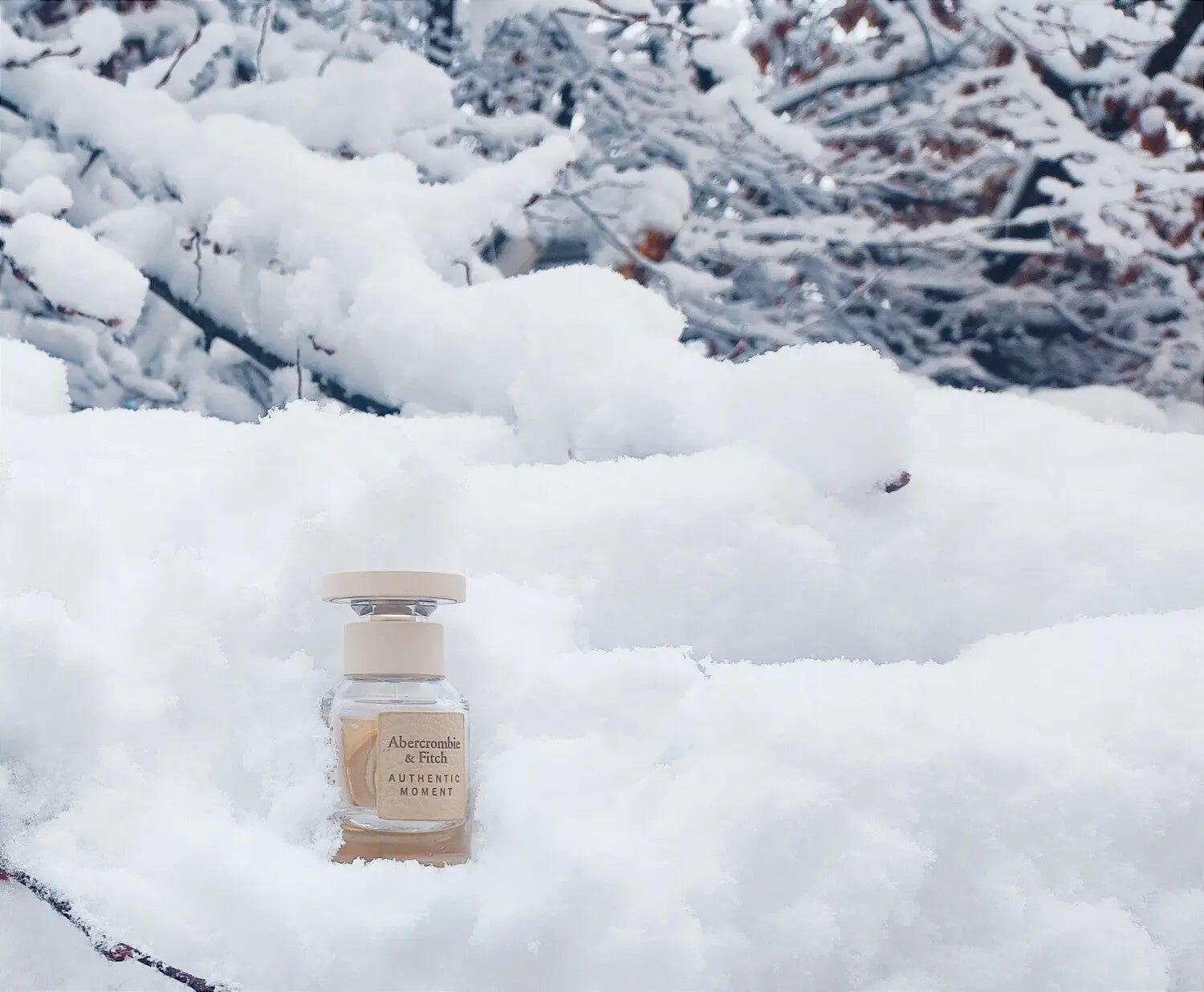 Bottle of Abercrombie & Fitch perfume in the snow