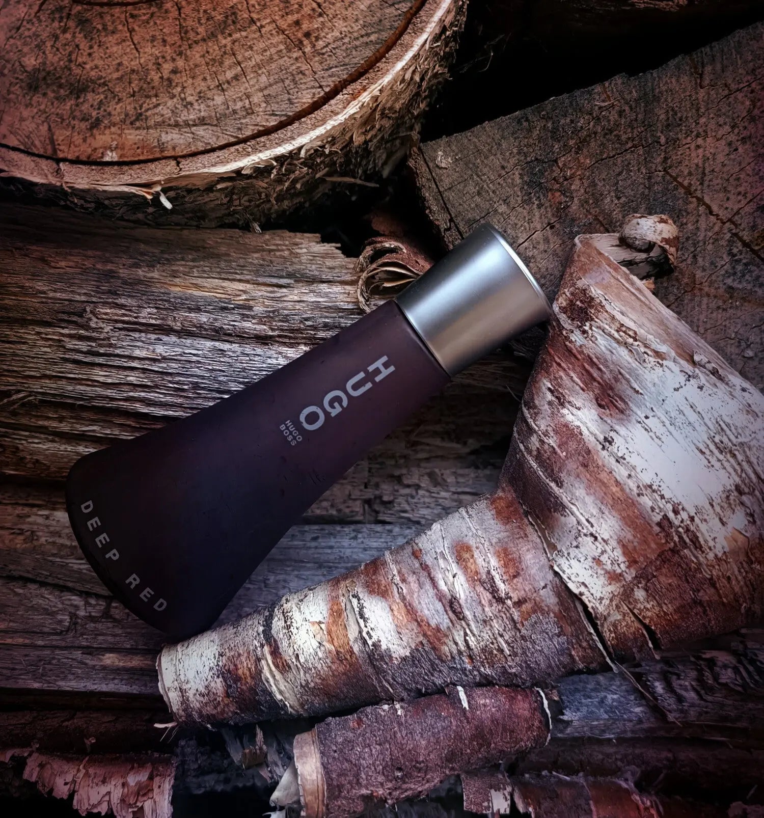 Vinegar bottle with 'Hugo' branding on a wooden surface