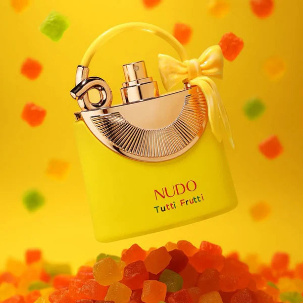 Yellow Nudo Tutti Frutti perfume bottle with a bow on a yellow background with colorful shapes.