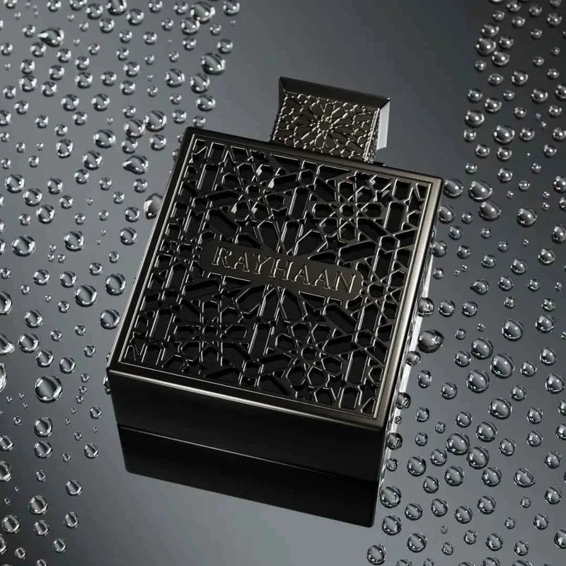 Black textured bottle on a reflective surface with water droplets