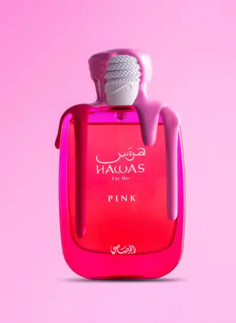 Pink perfume bottle with silver cap on a pink background