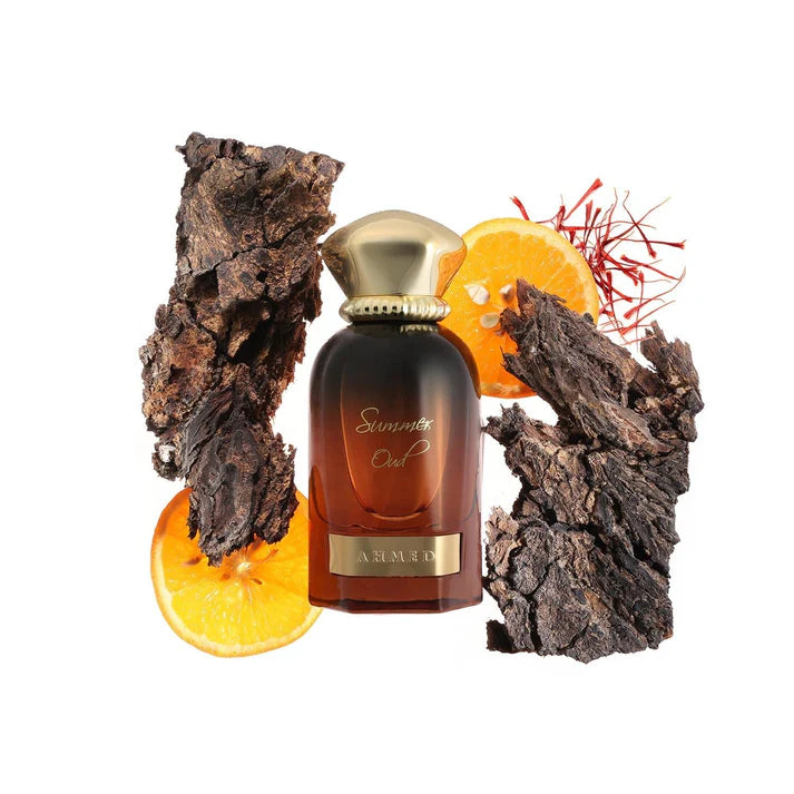 Ahmed Al Maghribi Summer Oud Perfume bottle with gold cap and dark brown body, surrounded by orange slices and dark wood pieces on a white background.