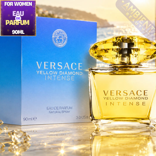 Versace Yellow Diamond Intense perfume bottle and packaging on a reflective surface with blurred background