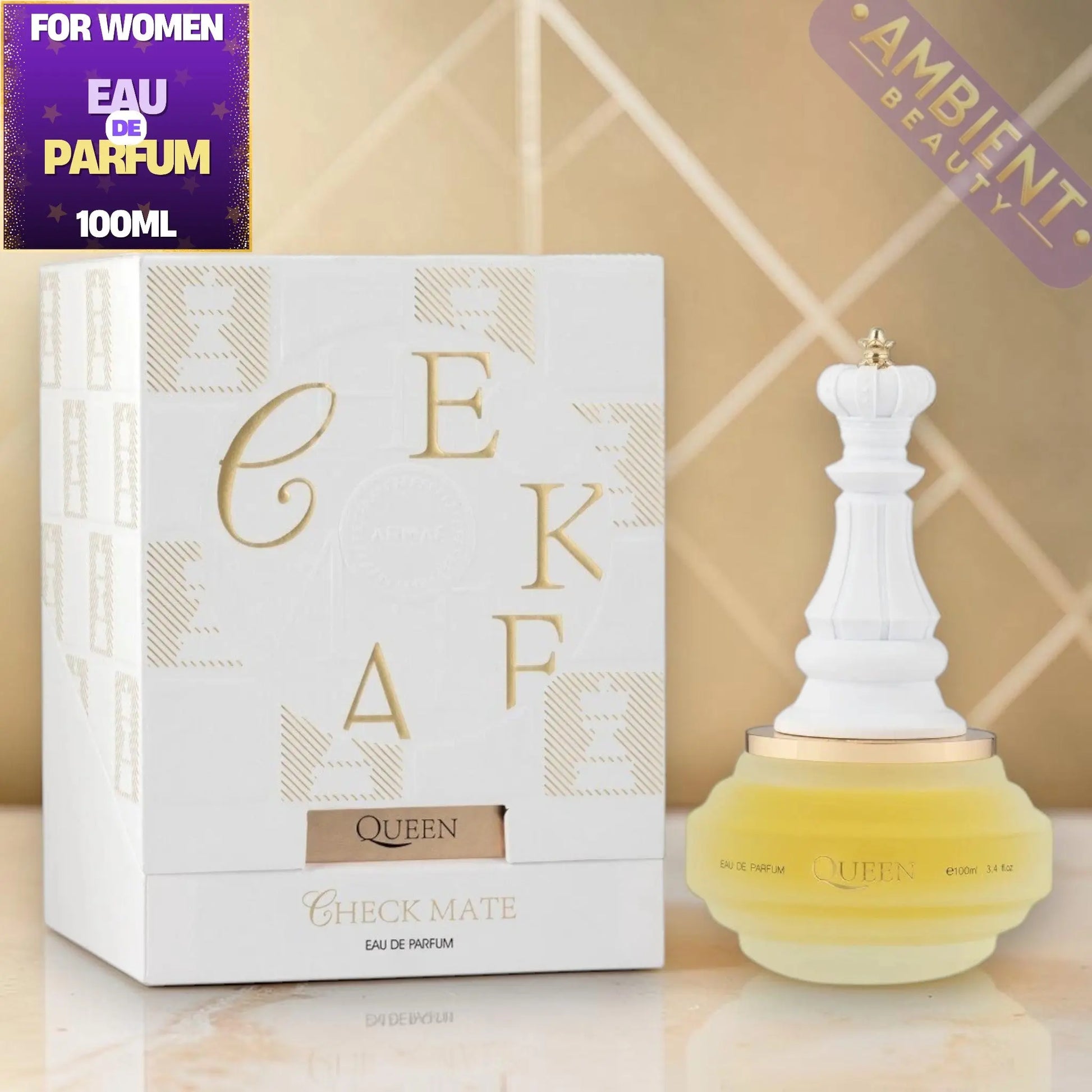 Perfume bottle and packaging with 'Queen' branding on a reflective surface.