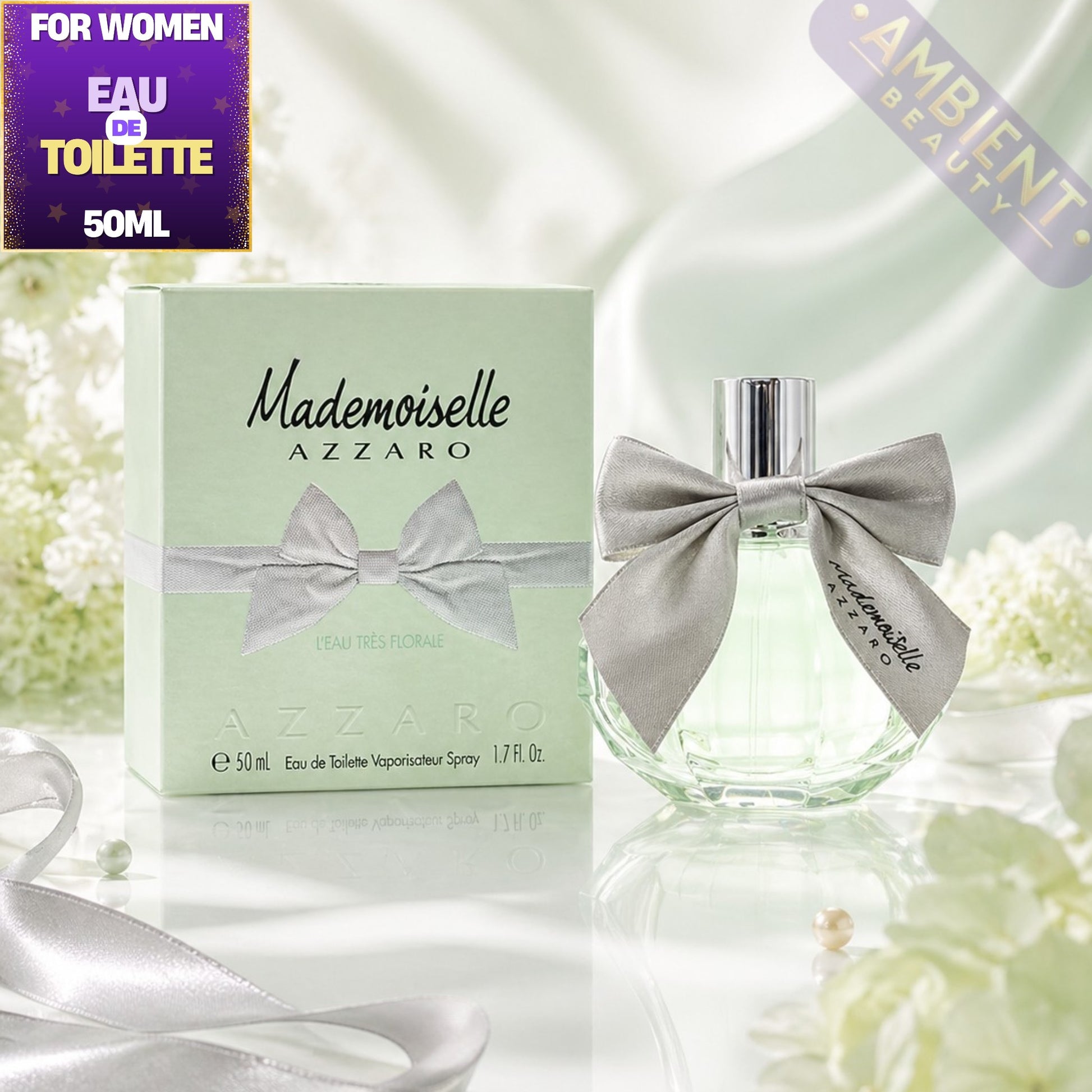 Azzaro Mademoiselle perfume bottle and packaging with flowers in the background