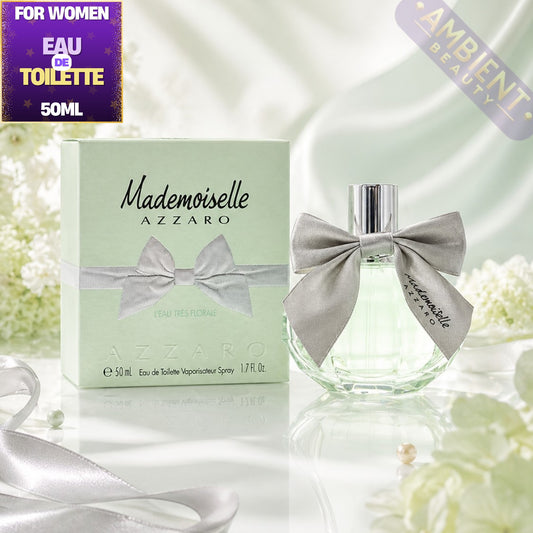Azzaro Mademoiselle perfume bottle and packaging with flowers in the background
