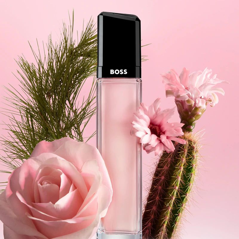 BOSS perfume bottle with pink flowers and cactus on a pink background
