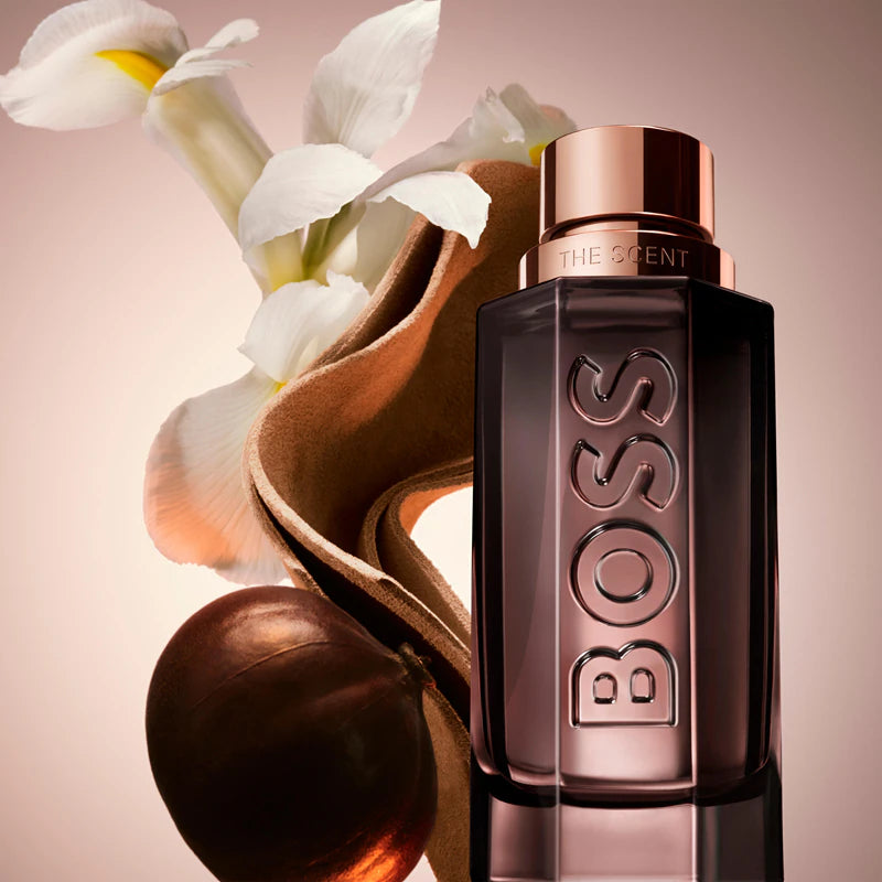 BOSS perfume bottle with flowers on a pink background