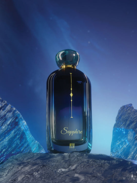 Ahmed Al Maghribi Sapphire Bottle of Sapphire perfume with a blue and gold design against a mountainous background