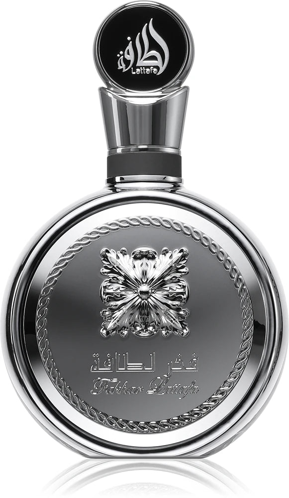 Lattafa Fakhar Platin Silver perfume bottle with intricate design and Arabic text on a white background
