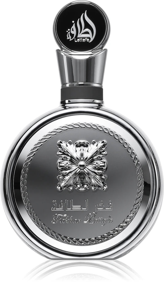 Lattafa Fakhar Platin Silver perfume bottle with intricate design and Arabic text on a white background