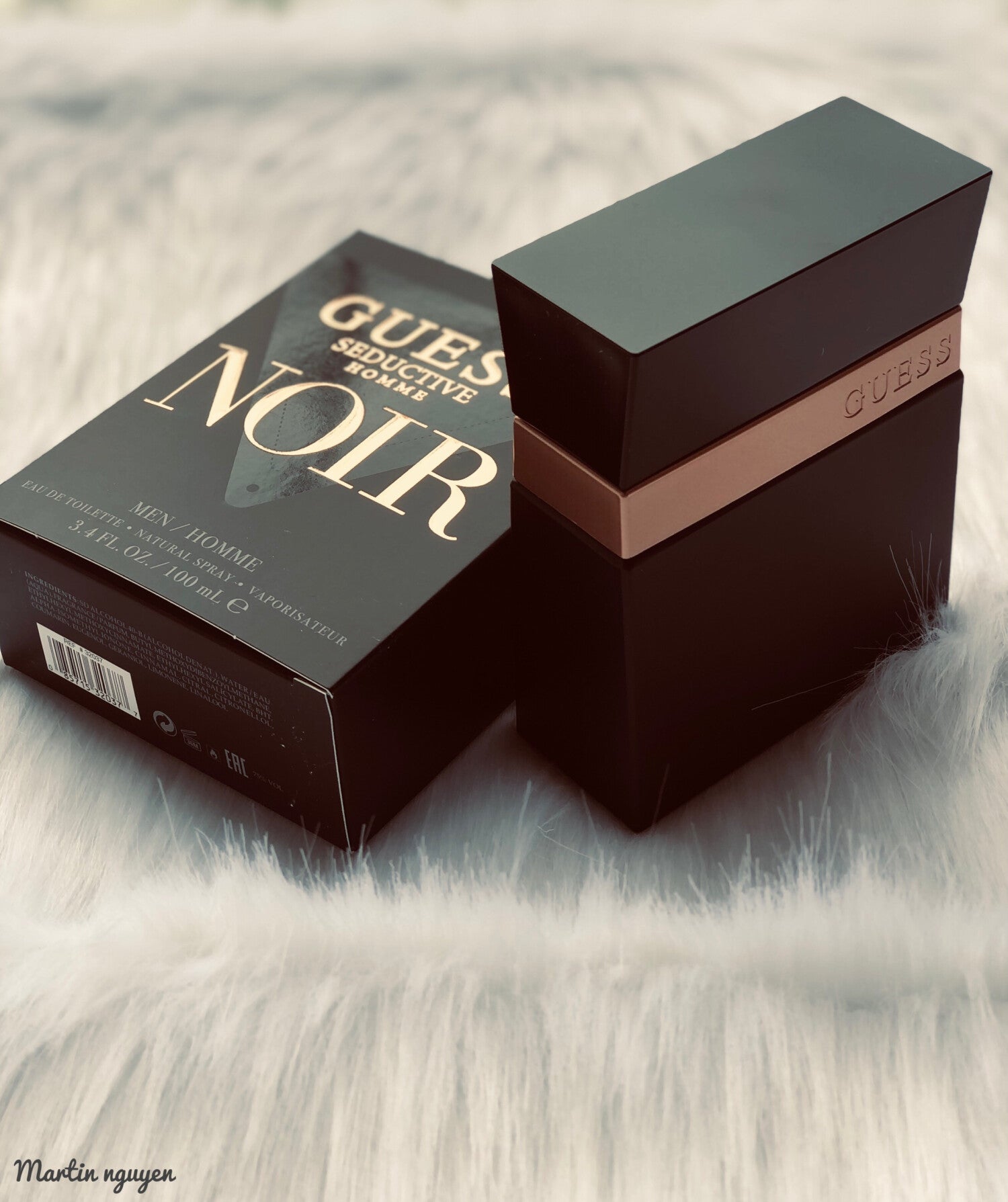 Guess Seductive Noir perfume packaging on a textured surface
