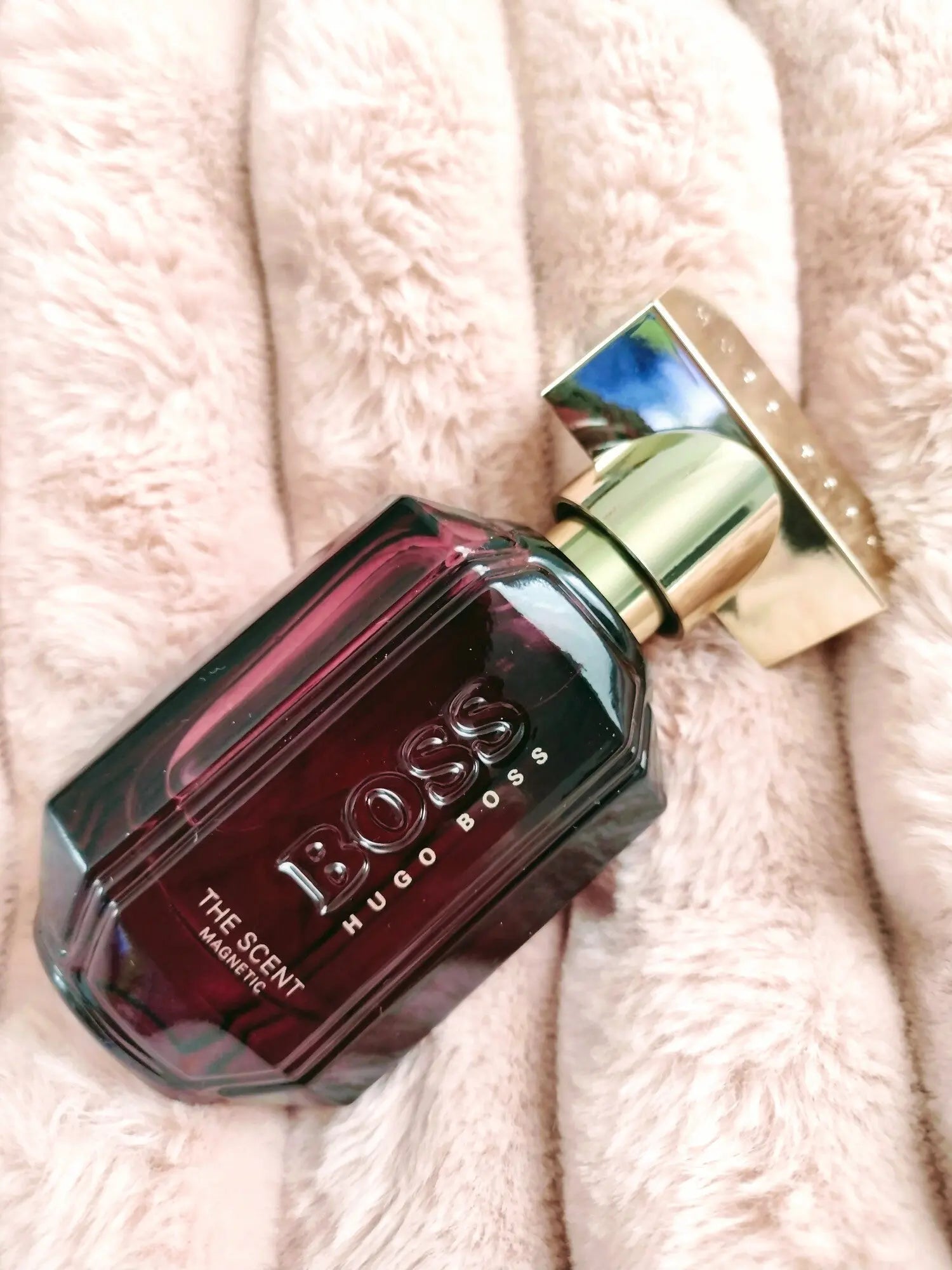 Hugo Boss perfume bottle on a soft pink background