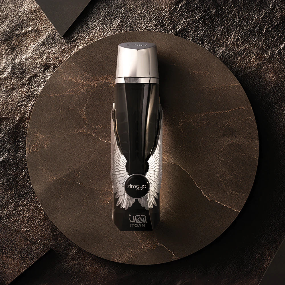 Zimaya Itqan Noir Black and silver bottle on a round brown coaster with a dark stone background