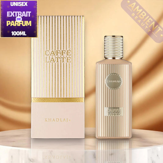 A bottle and box of Khadlaj Caffe Latte Unisex Extrait de Parfum, 100ml. The packaging features a pale pink base with gold vertical stripes and gold lettering, alongside a matching ribbed metallic gold bottle.
