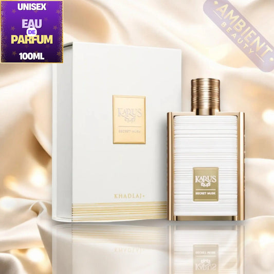 Kharus Khadlaj Secret Musk Eau De Parfum 100ml bottle and its white packaging box, both featuring gold accents, set against a luxurious beige satin background with a reflection below.