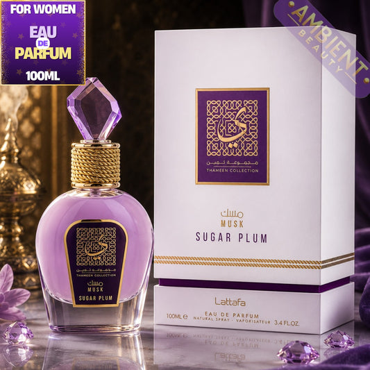 Lattafa Sugar Plum Musk perfume bottle and packaging on a reflective surface with decorative elements.