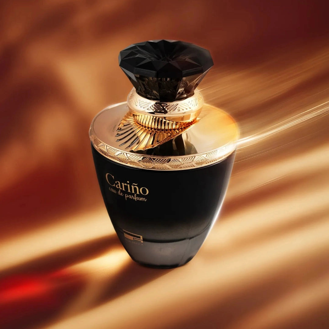 Luxurious black and gold perfume bottle with 'Carino' branding on a warm brown background