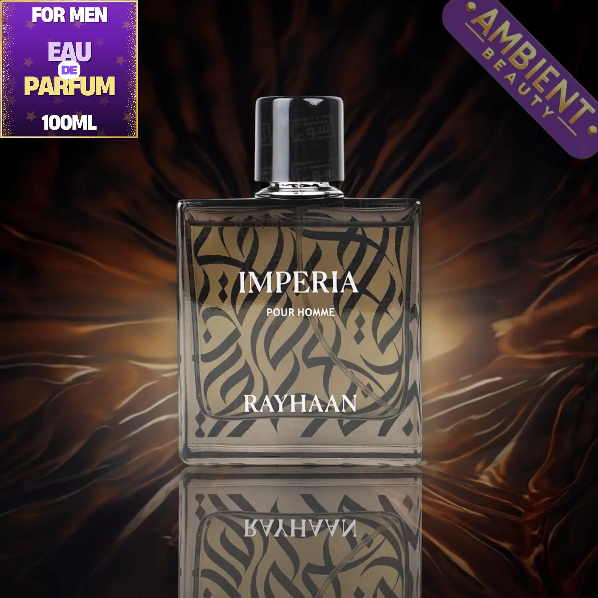 Rayhaan Imperia Pour Homme 100ml perfume bottle, featuring a clear glass rectangular body with black Arabic calligraphy on a beige background, a black cap, and a reflective surface below. The background is a dark, draped brown fabric with a purple 'For Men Eau De Parfum 100ML' badge on the top left and a purple 'Ambient Beauty' badge on the top right.
