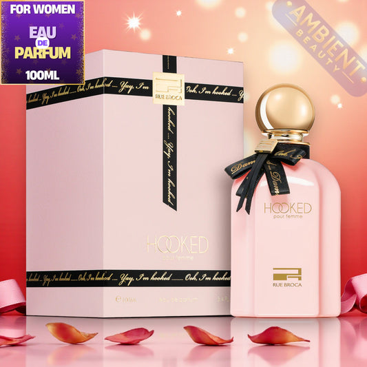 Rue broca Hooked Pour Femme Pink perfume bottle with gold cap and packaging on a pink background