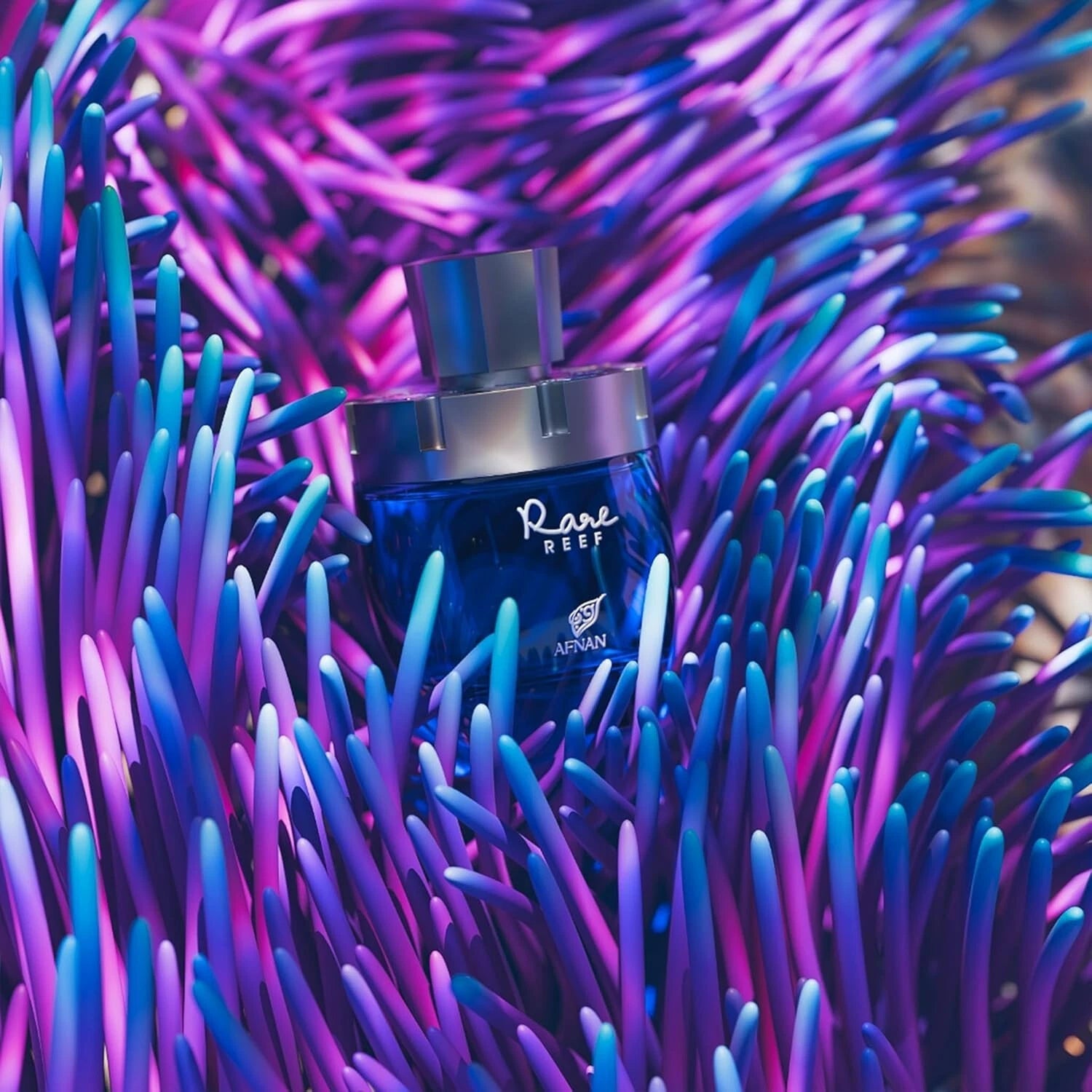 Perfume bottle labeled 'Rare Reef' by Afnan on a vibrant purple and blue coral background