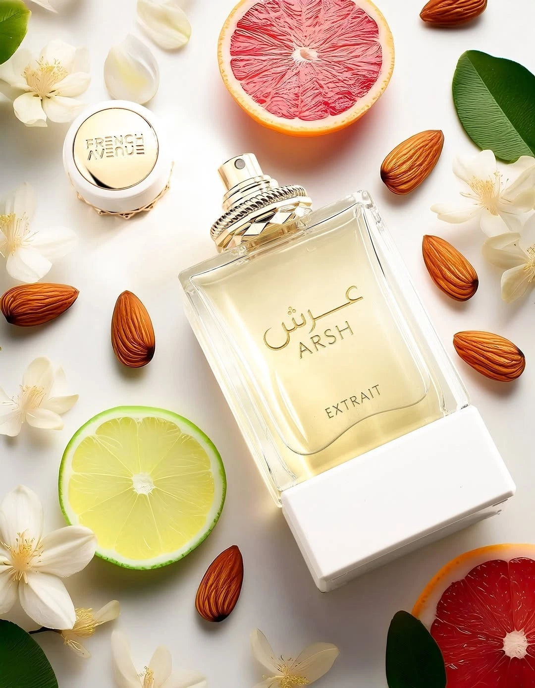French Avenue Arsh perfume bottle with citrus fruits, almonds, and flowers on a white background